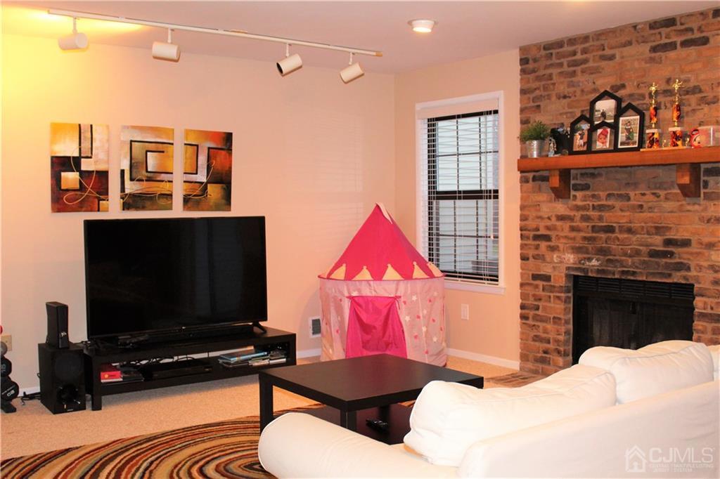 4602 Stonehedge Road, Unit 4602 Edison, NJ 08820 - Photo 22 of 25 a bedroom with a bed and a flat screen tv