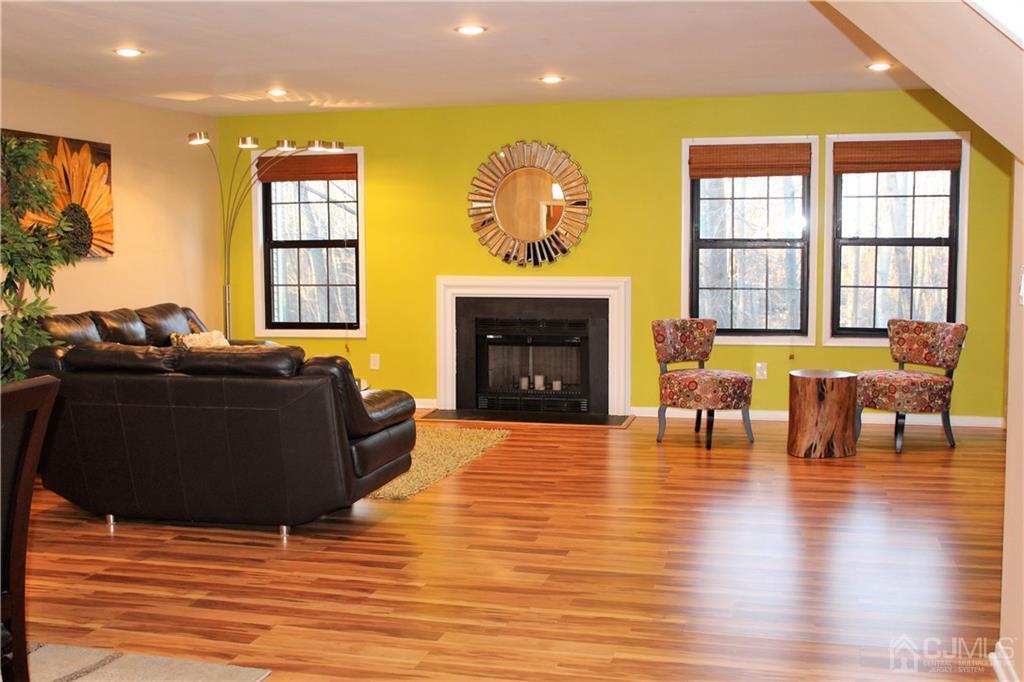 4602 Stonehedge Road, Unit 4602 Edison, NJ 08820 - Photo 5 of 25 a living room with furniture and a fireplace