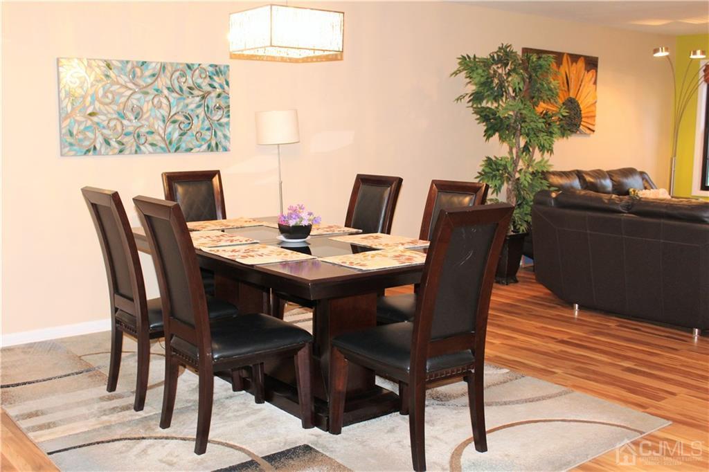4602 Stonehedge Road, Unit 4602 Edison, NJ 08820 - Photo 7 of 25 a view of a dining room with furniture and wooden floor