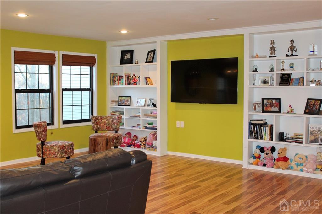 4602 Stonehedge Road, Unit 4602 Edison, NJ 08820 - Photo 8 of 25 a living room with furniture and a flat screen tv