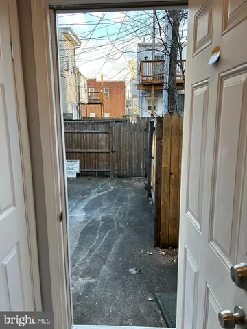 a view of a house with a door and wooden walls