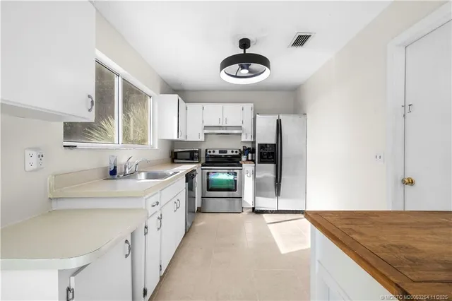 a kitchen with a sink stove and cabinets