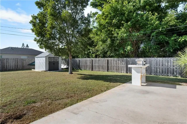 a front view of house with yard and trees