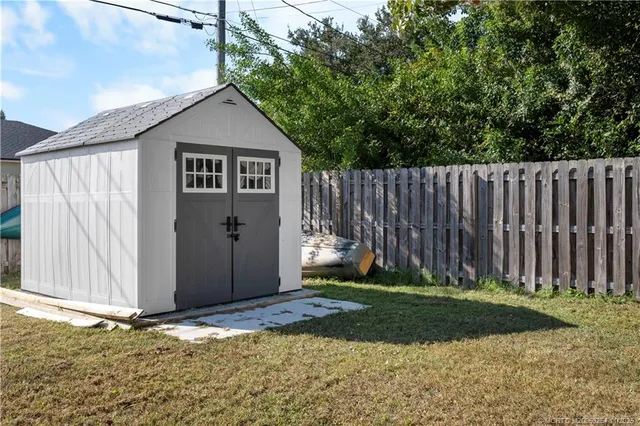 a front view of a house with a garden and patio