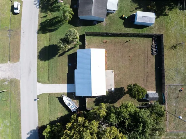 an aerial view of residential houses with outdoor space and street view