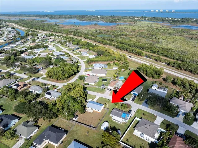 an aerial view of residential building and lake