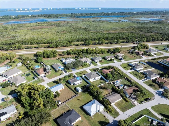 an aerial view of residential houses with outdoor space and swimming pool