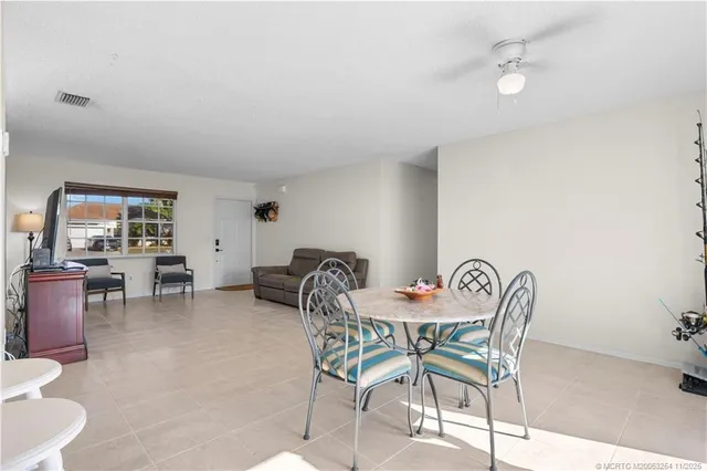 a dining room with furniture and a chandelier