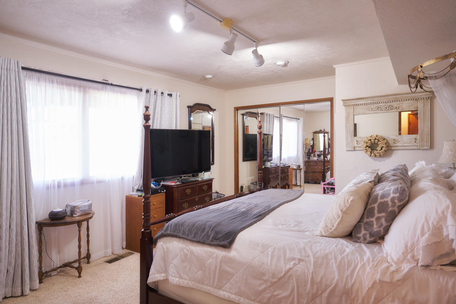 150 Nick Young Road Eagle Point, OR 97524 - Photo 27 of 41 a bedroom with a bed and a flat tv screen on wall