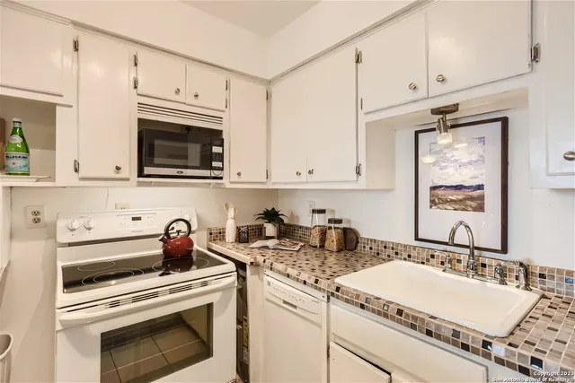 a view of a dining room with furniture and a potted plant