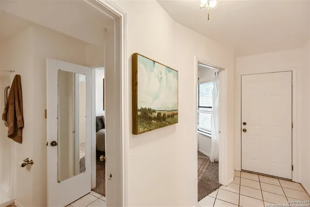 a view of two chairs and a table in the patio