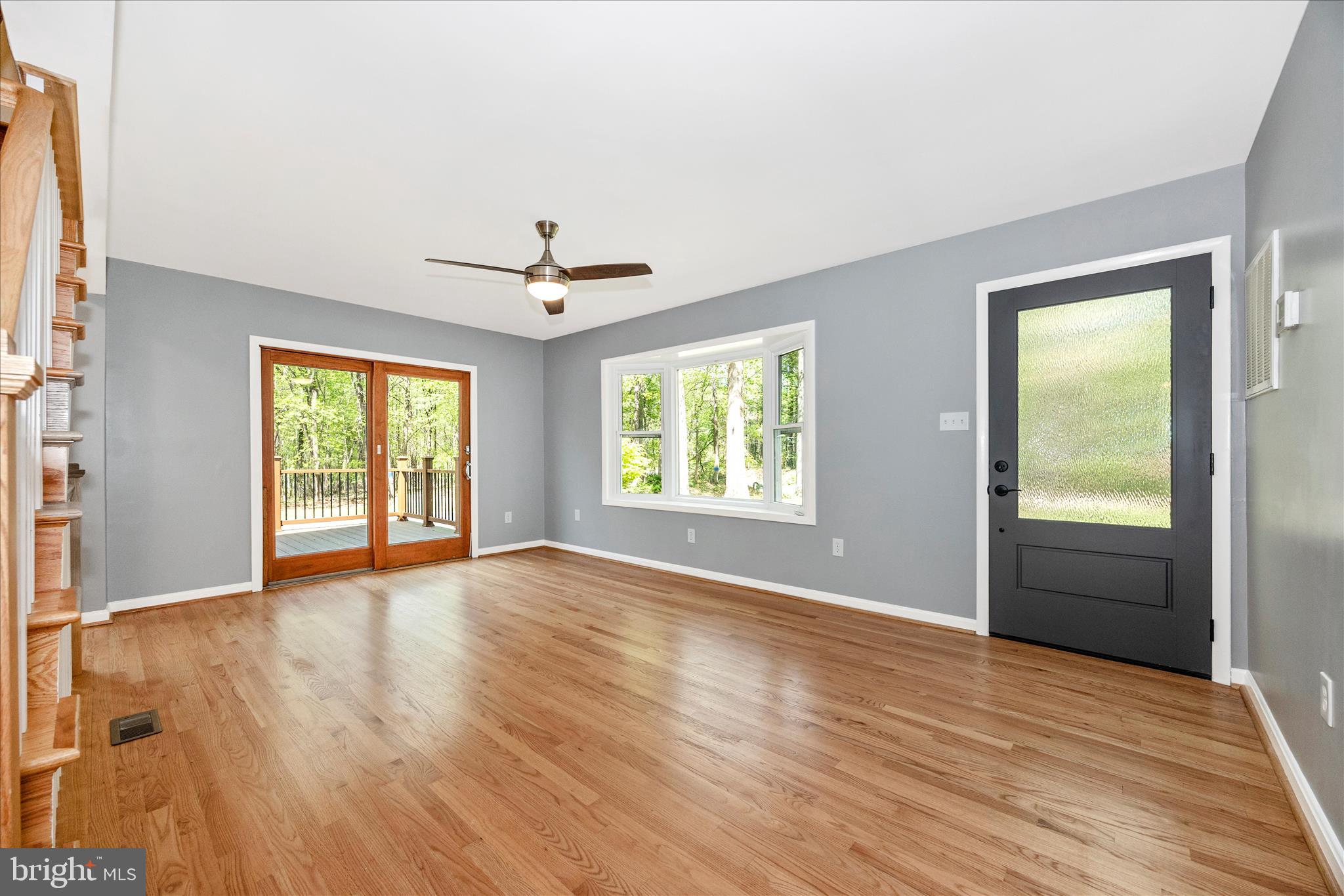 6518 Woodville Road Mount Airy, MD 21771 - Photo 7 of 53 an empty room with wooden floor and windows