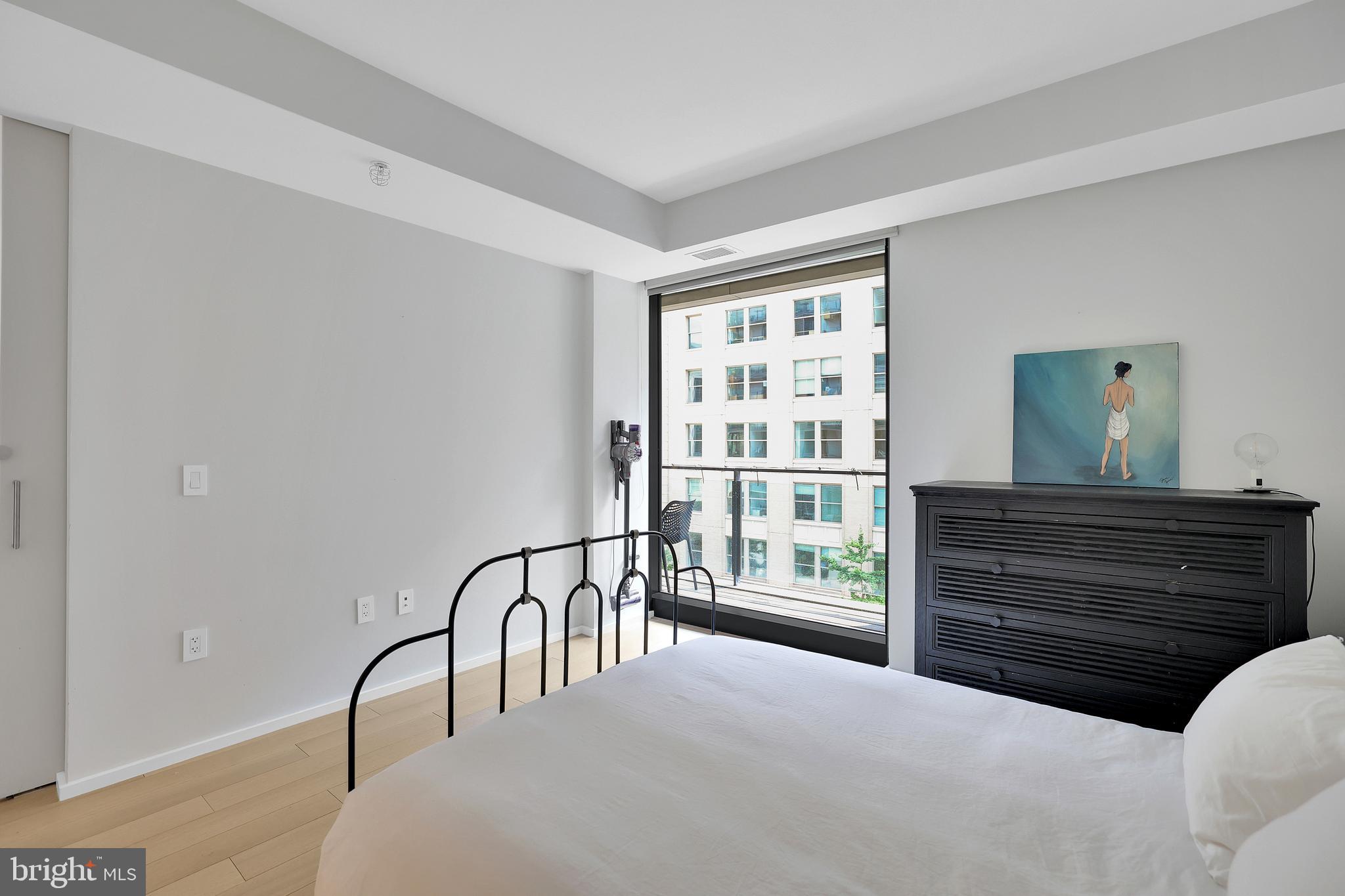 925 H Street Northwest, Unit 506 Washington, DC 20001 - Photo 11 of 36 a bedroom with furniture and a window