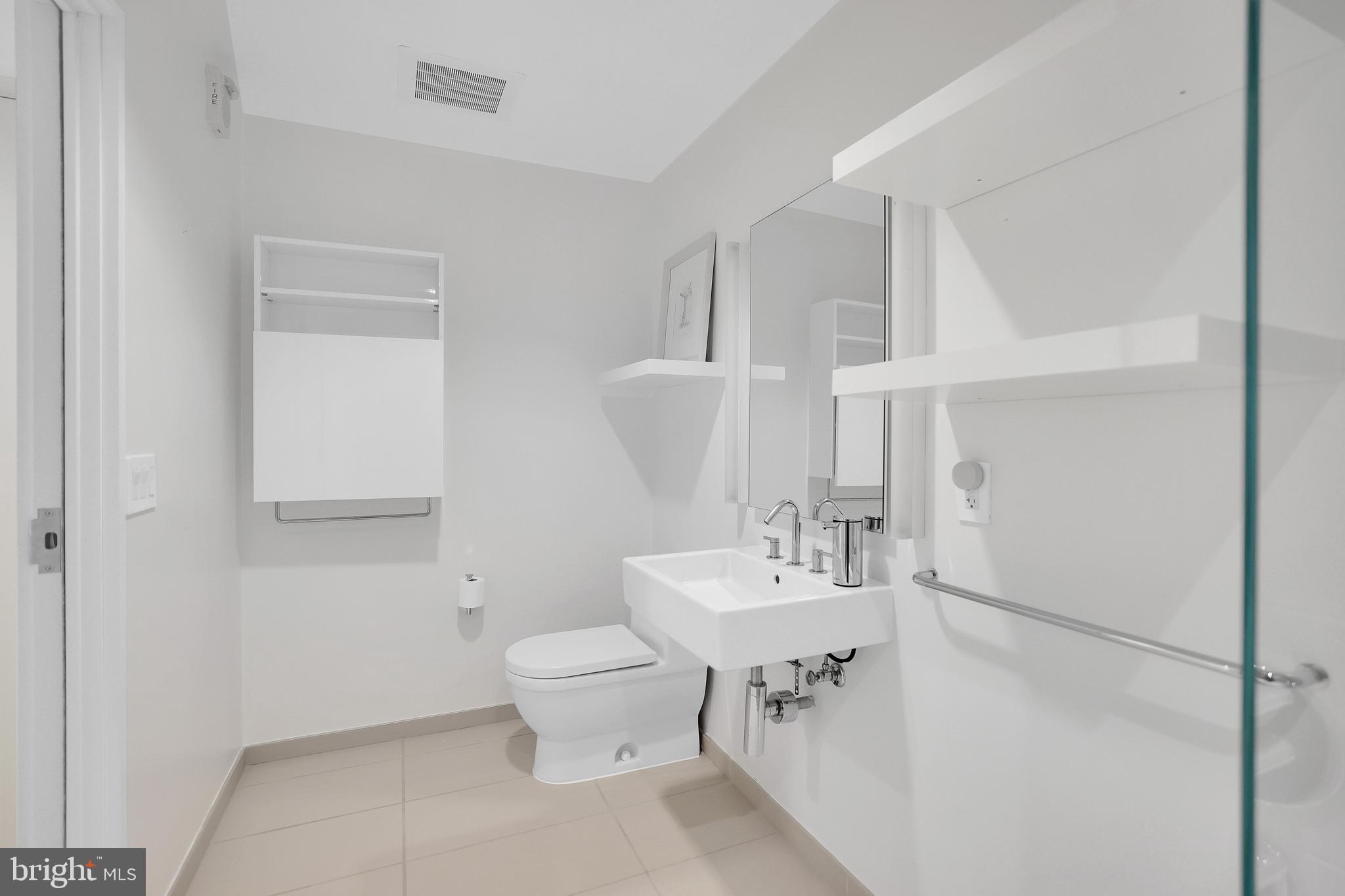 925 H Street Northwest, Unit 506 Washington, DC 20001 - Photo 14 of 36 a bathroom with a sink toilet and vanity