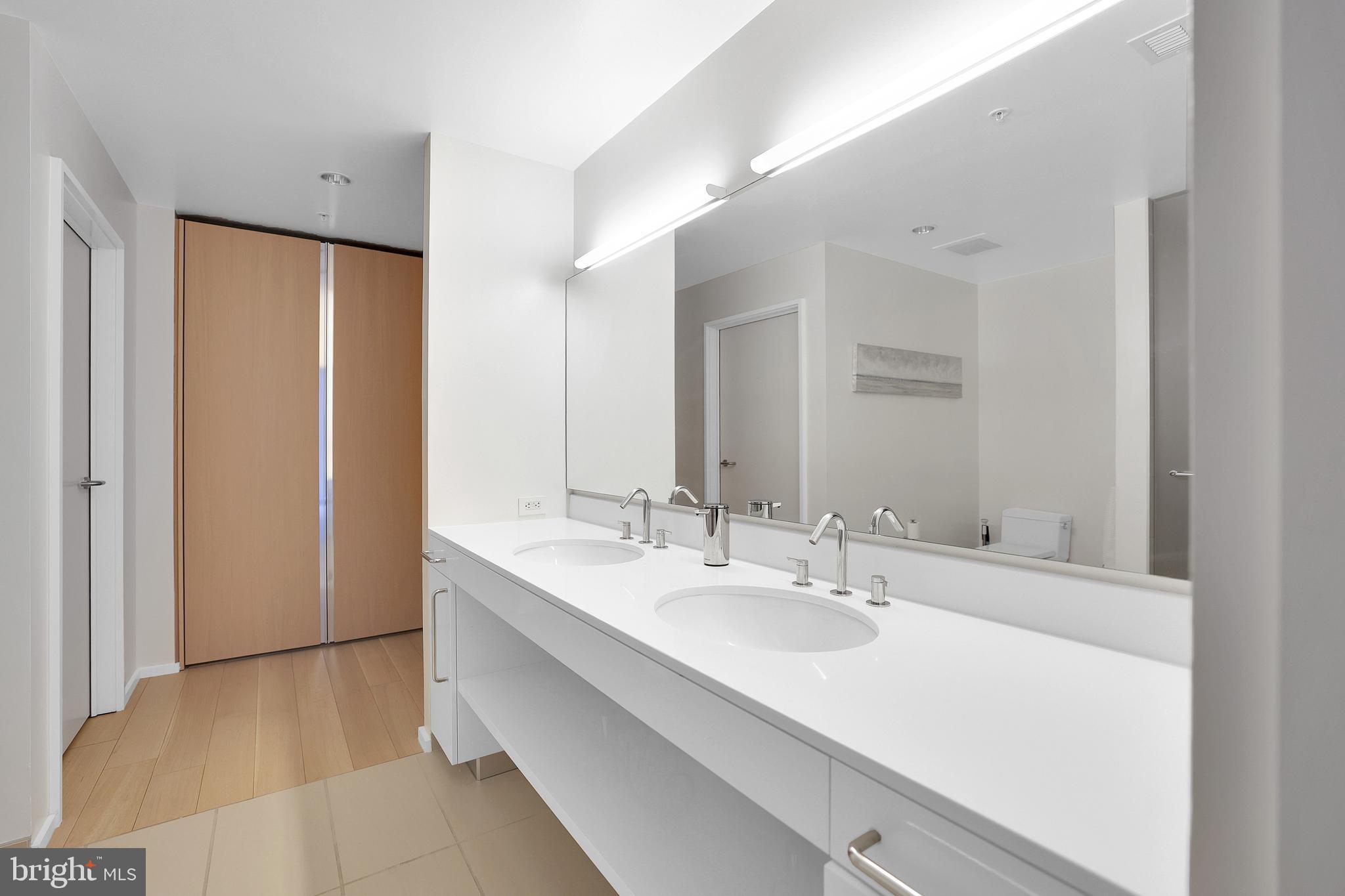 925 H Street Northwest, Unit 506 Washington, DC 20001 - Photo 15 of 36 a bathroom with a double vanity sink and mirror