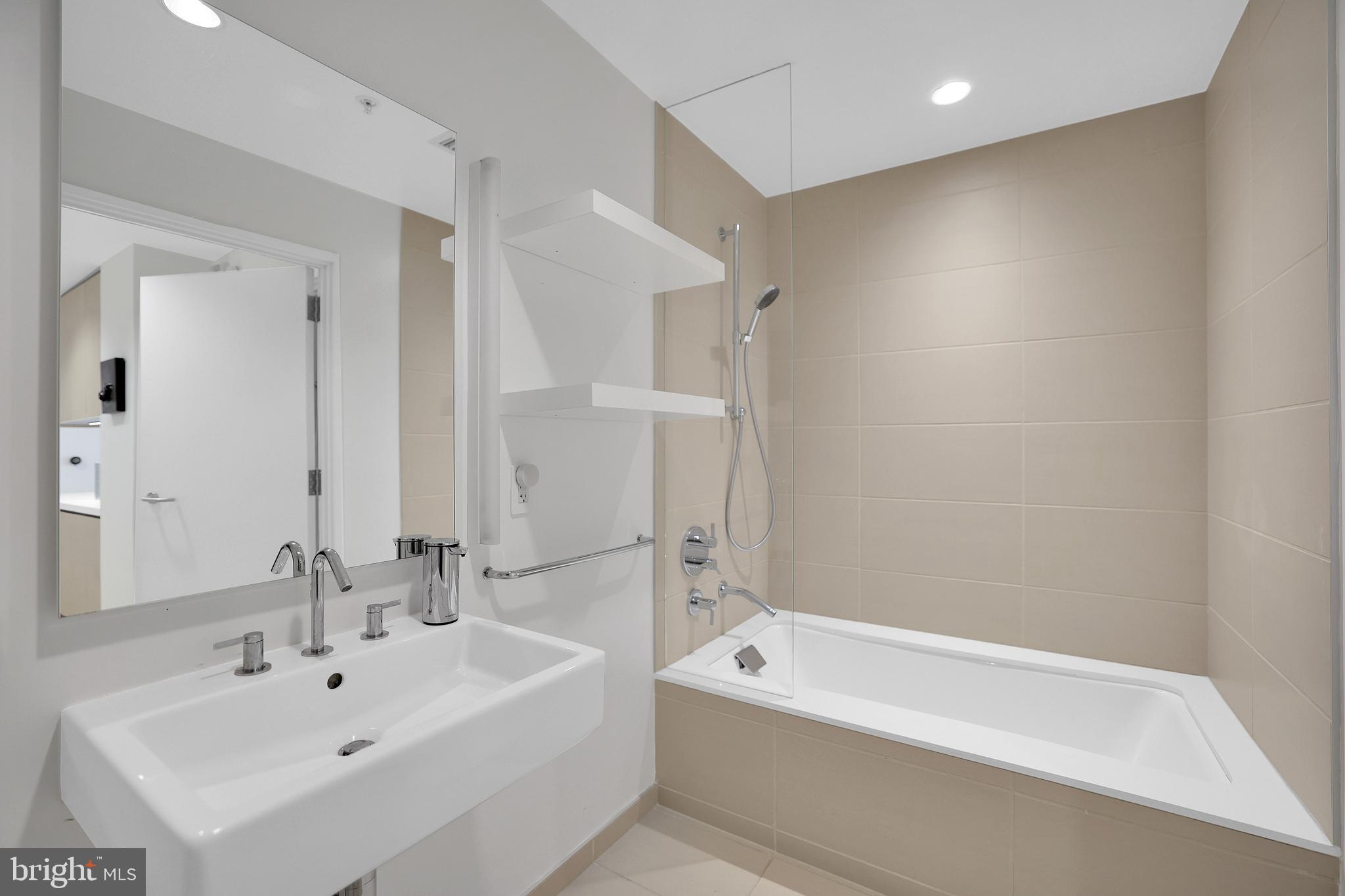 925 H Street Northwest, Unit 506 Washington, DC 20001 - Photo 20 of 36 a bathroom with a bathtub and a sink