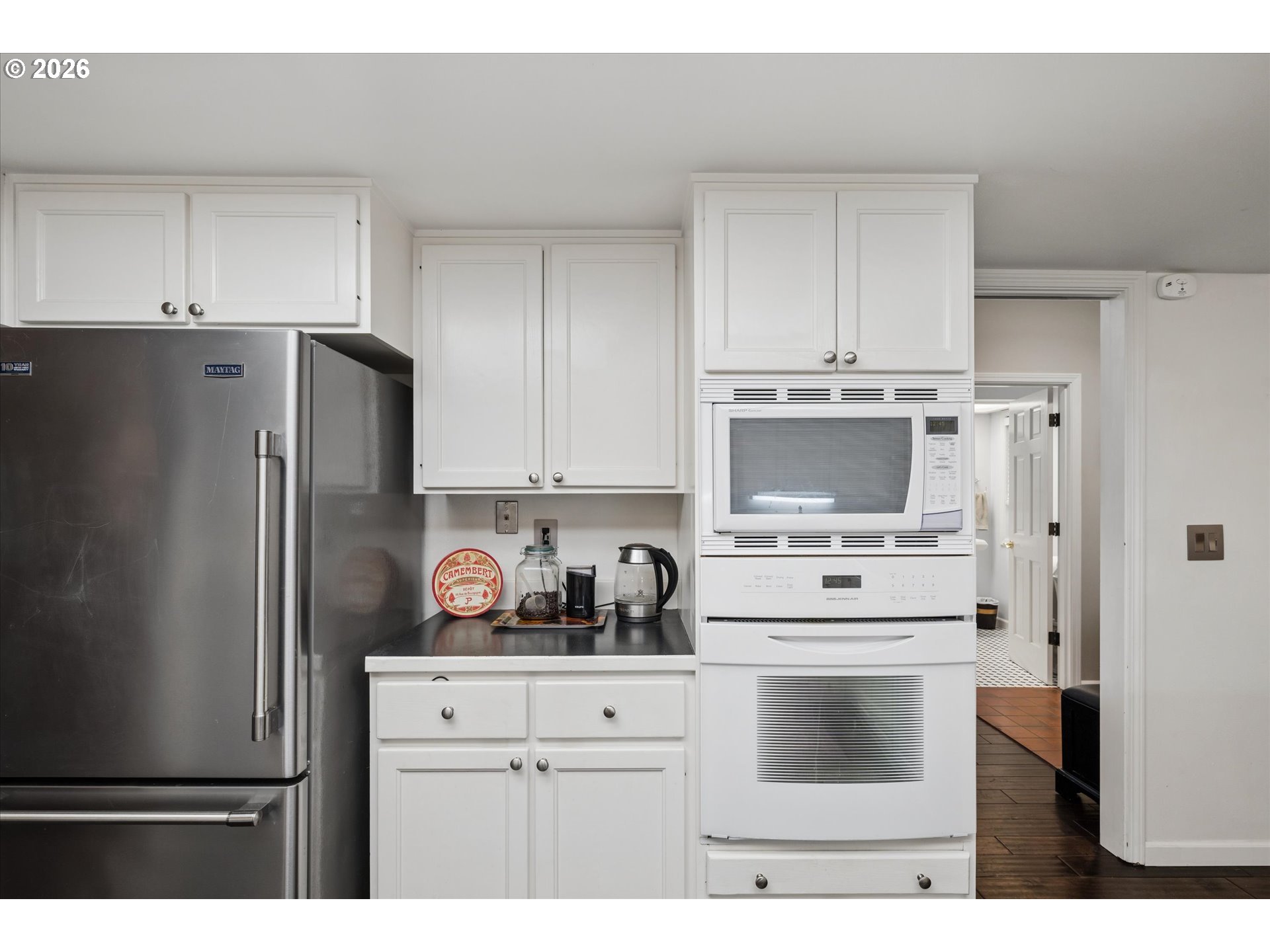 599 Wimbledon Court Eugene, OR 97401 - Photo 13 of 45 a kitchen with stainless steel appliances a refrigerator a stove and white cabinets