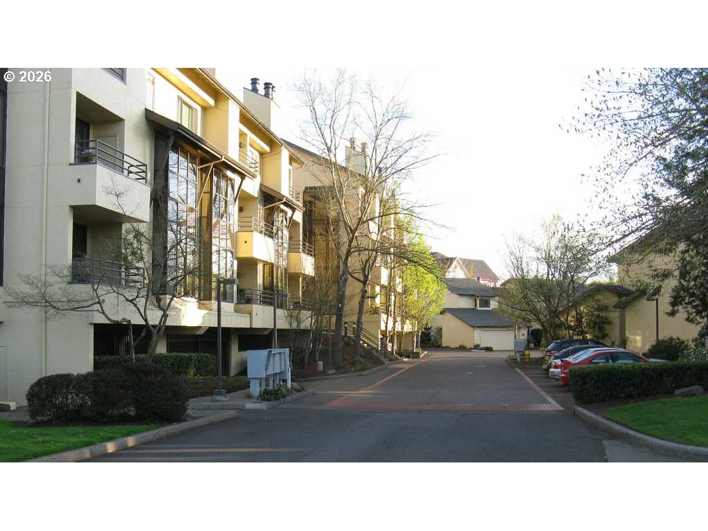 599 Wimbledon Court Eugene, OR 97401 - Photo 43 of 45 a street view with tall buildings and cars parked on road