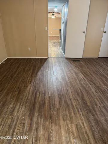 a view of a room with wooden floor