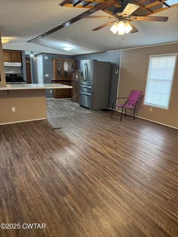 a view of kitchen with furniture and wooden floor