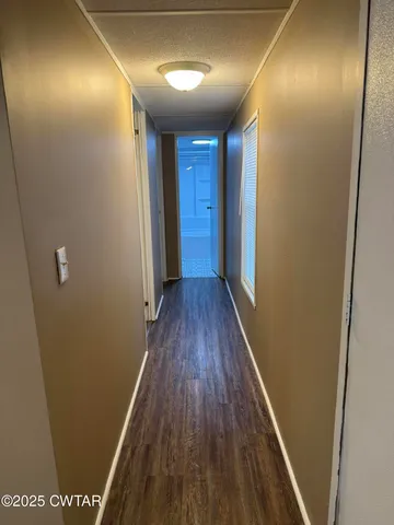 a view of hallway with wooden floor