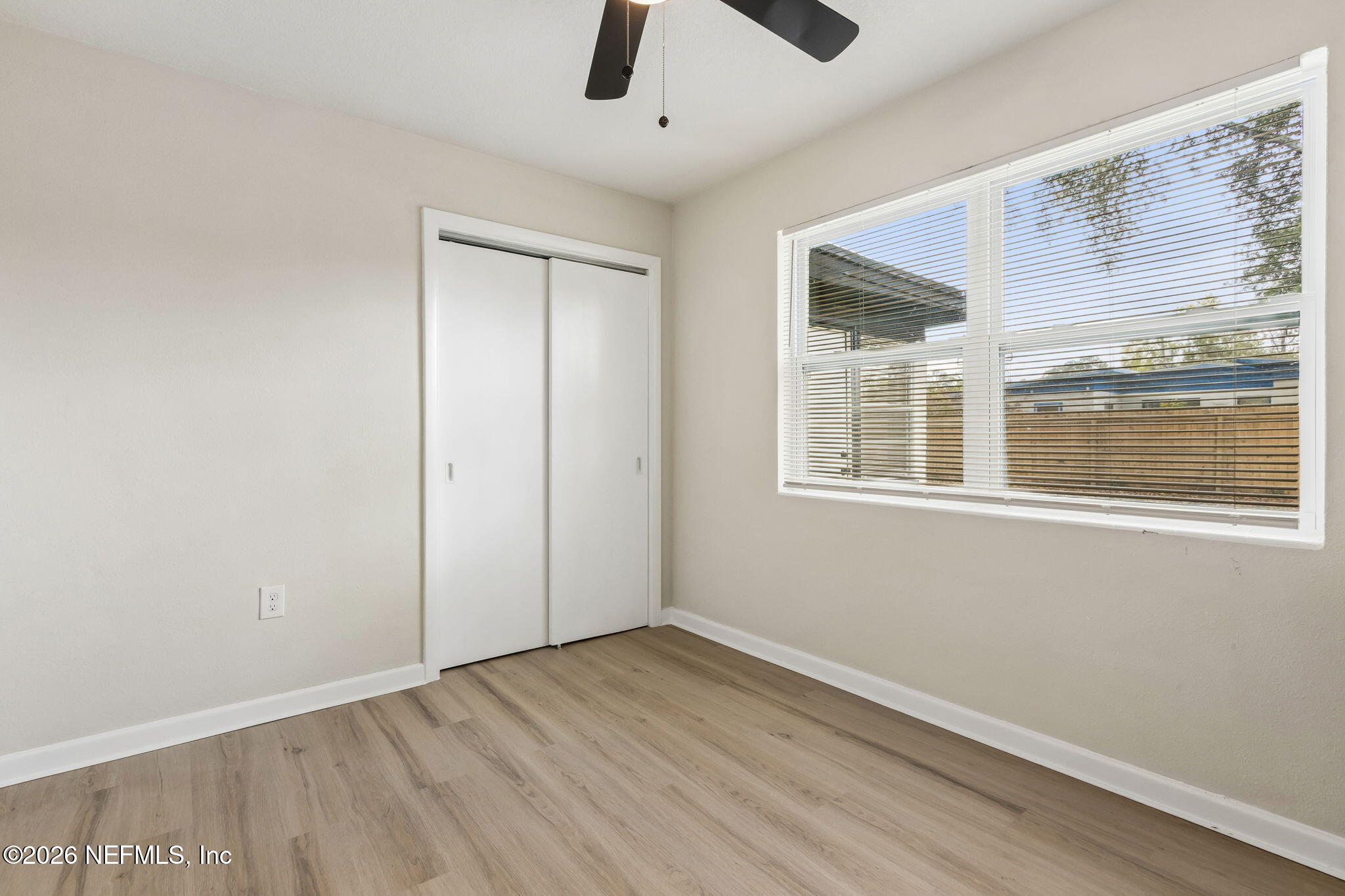 3668 Marianna Road Jacksonville, FL 32217 - Photo 19 of 27 a view of an empty room with window and wooden floor