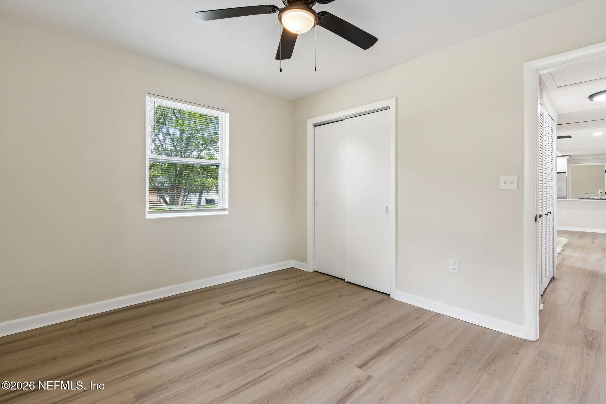 3668 Marianna Road Jacksonville, FL 32217 - Photo 22 of 27 a view of an empty room with wooden floor and a window