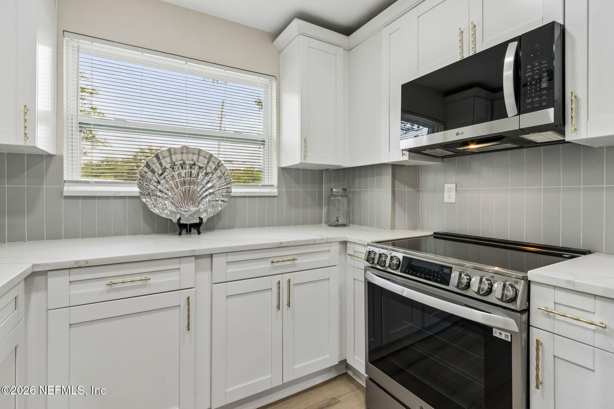3668 Marianna Road Jacksonville, FL 32217 - Photo 8 of 27 a kitchen with stainless steel appliances white cabinets and a stove top oven