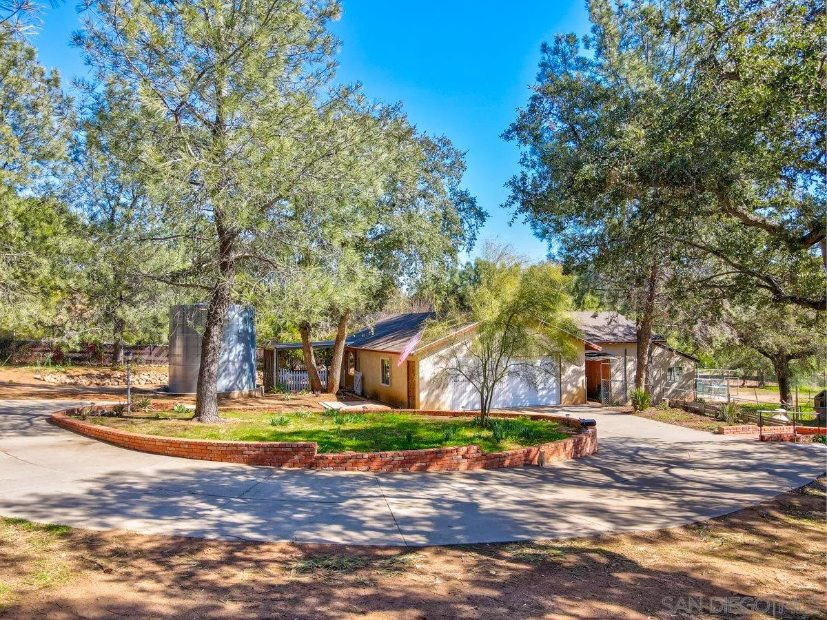 23415 Japatul Valley Road Alpine, CA 91901 - Photo 4 of 49 a view of a yard with yellow house