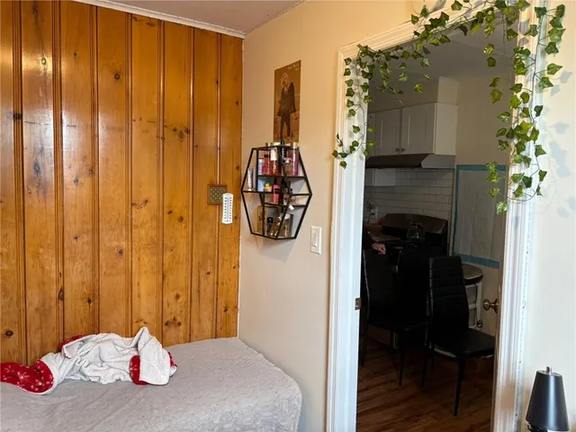 a bedroom with a bed and a potted plant