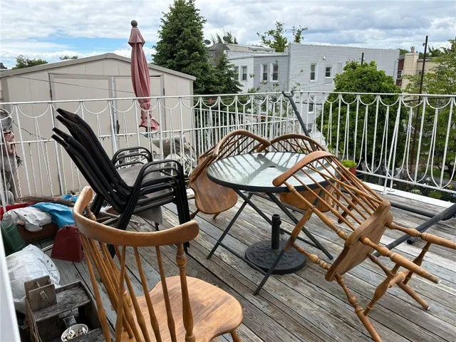 a view of a chairs and table in the balcony