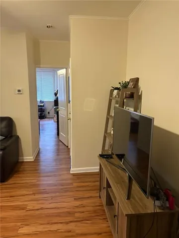 a view of a living room with furniture and wooden floor