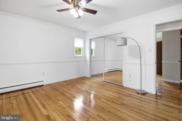 a view of an empty room with wooden floor