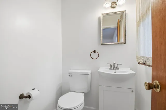 a bathroom with a sink toilet and mirror