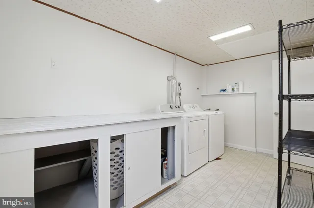 a utility room with cabinets washer and dryer