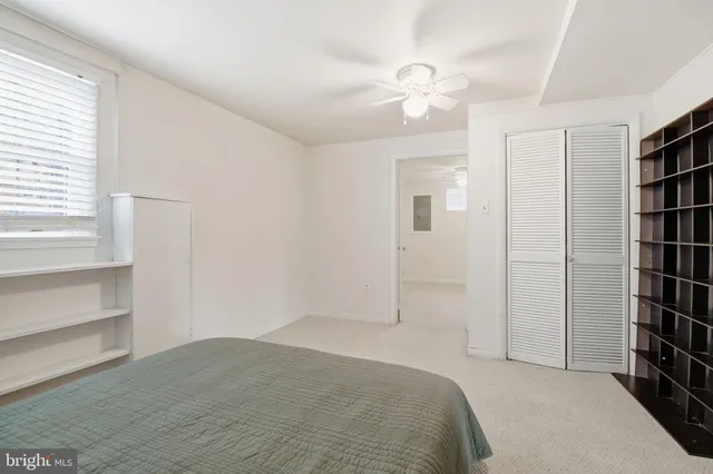 an empty room with closet and windows