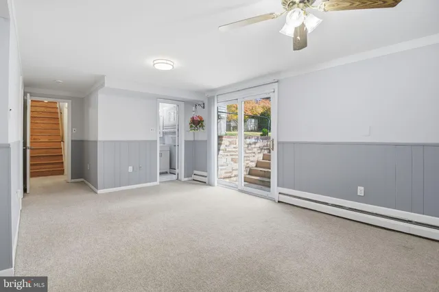 a view of an empty room with a fireplace and a window