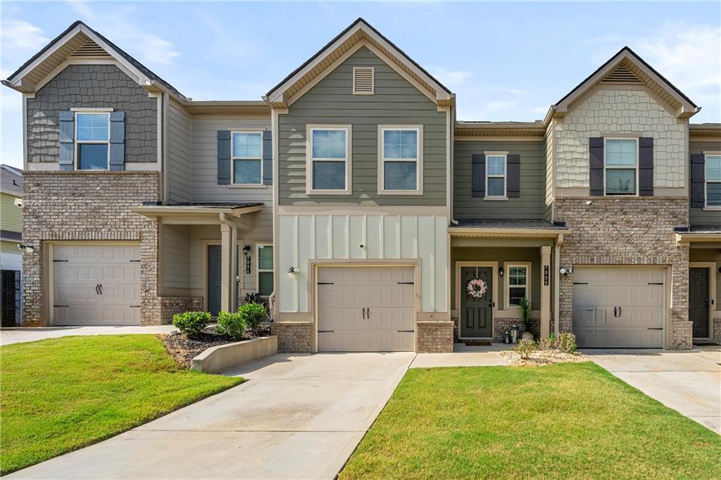7098 Chara Lane Atlanta, GA 30331 - Photo 1 of 25 a front view of a house with a yard and garage