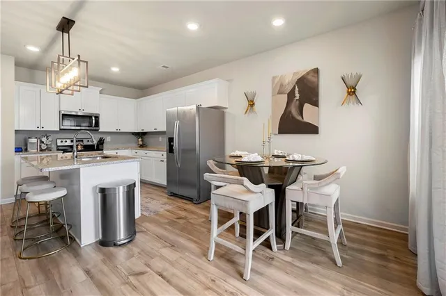 a bedroom with a bed a couch and a chandelier