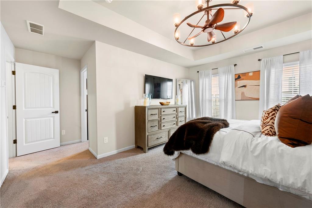 7098 Chara Lane Atlanta, GA 30331 - Photo 14 of 25 a bedroom with a bed and a chandelier