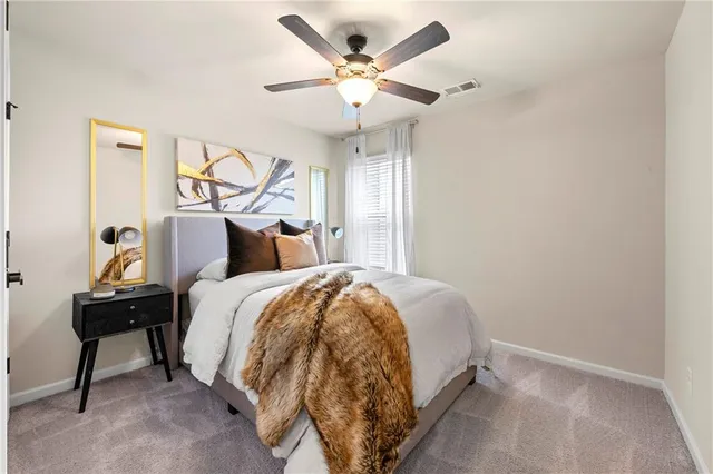 a bathroom with a granite countertop sink toilet and mirror