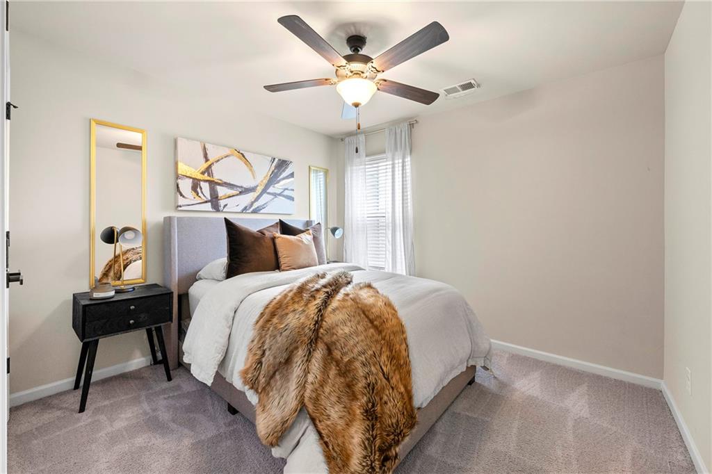 7098 Chara Lane Atlanta, GA 30331 - Photo 19 of 25 a bed sitting in a bedroom next to a window and a chandelier