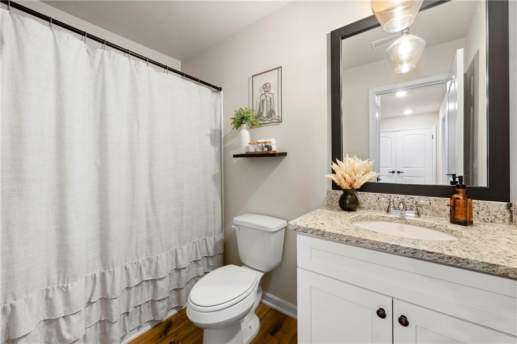 7098 Chara Lane Atlanta, GA 30331 - Photo 20 of 25 a bathroom with a granite countertop sink toilet and mirror