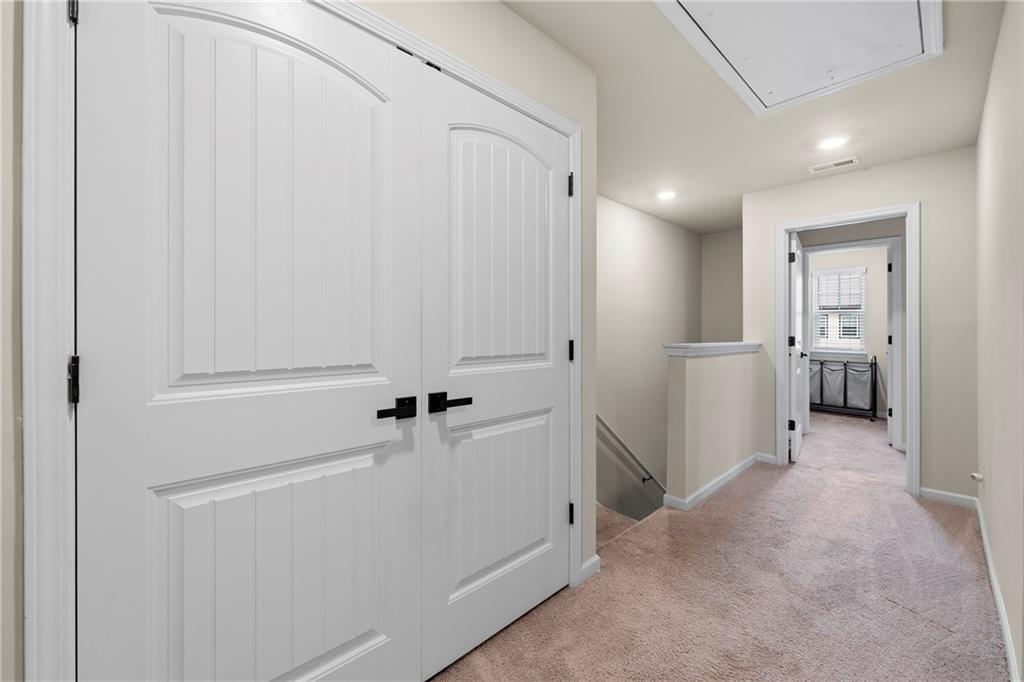 7098 Chara Lane Atlanta, GA 30331 - Photo 23 of 25 a view of a hallway with closet and wooden door