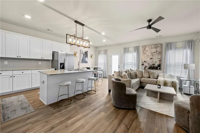 a living room with furniture or chandelier and a wooden floor