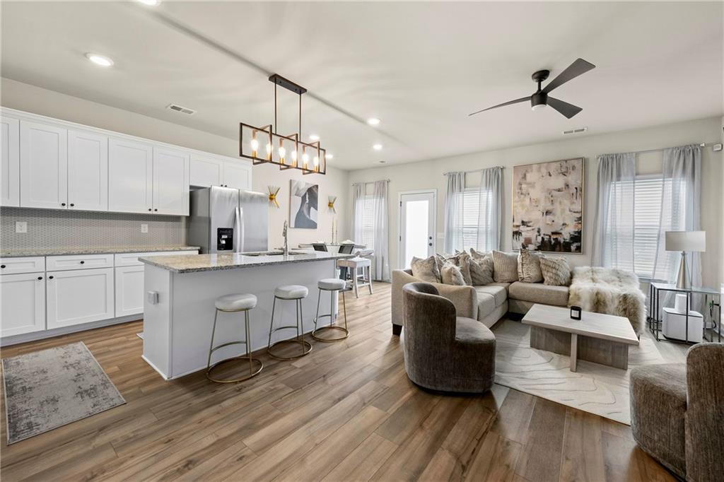 7098 Chara Lane Atlanta, GA 30331 - Photo 3 of 25 a living room with furniture or chandelier and a wooden floor