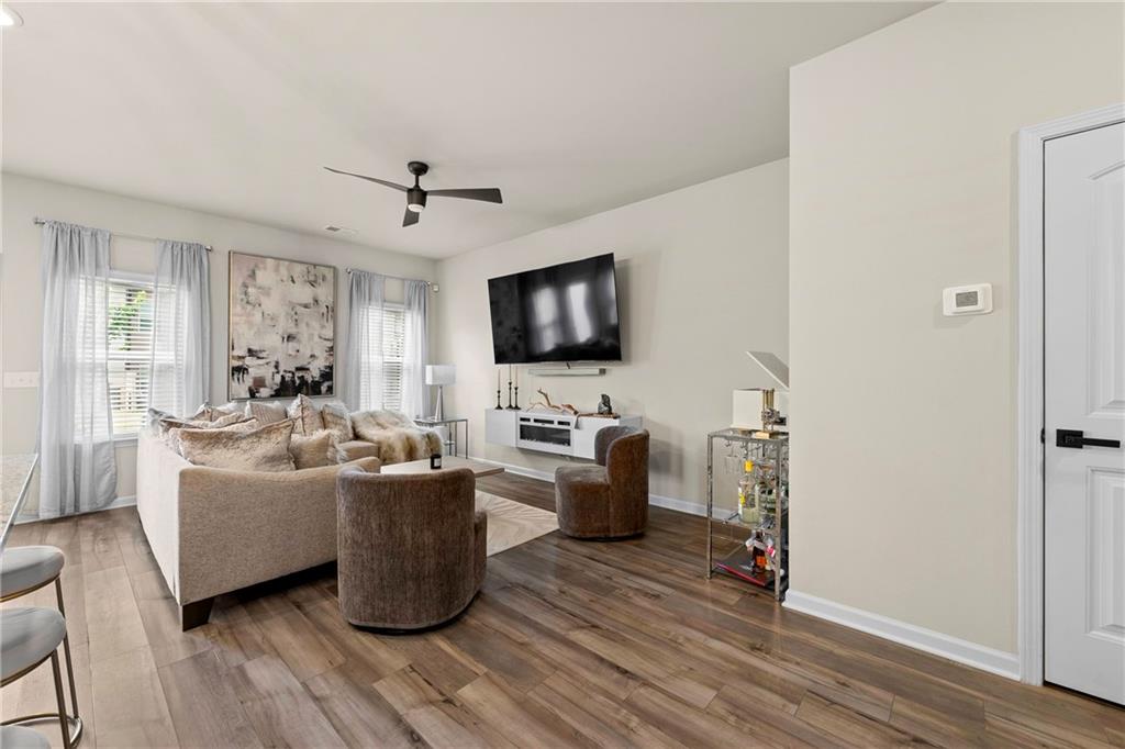 7098 Chara Lane Atlanta, GA 30331 - Photo 4 of 25 a living room with furniture a flat screen tv and wooden floor