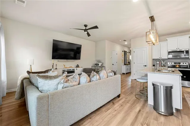 a view of a kitchen area kitchen island dining table and wooden floor