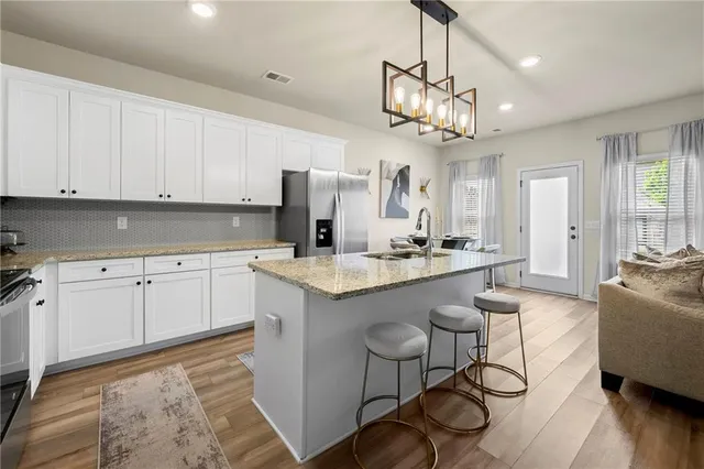 a kitchen with a sink a counter top space and stainless steel appliances