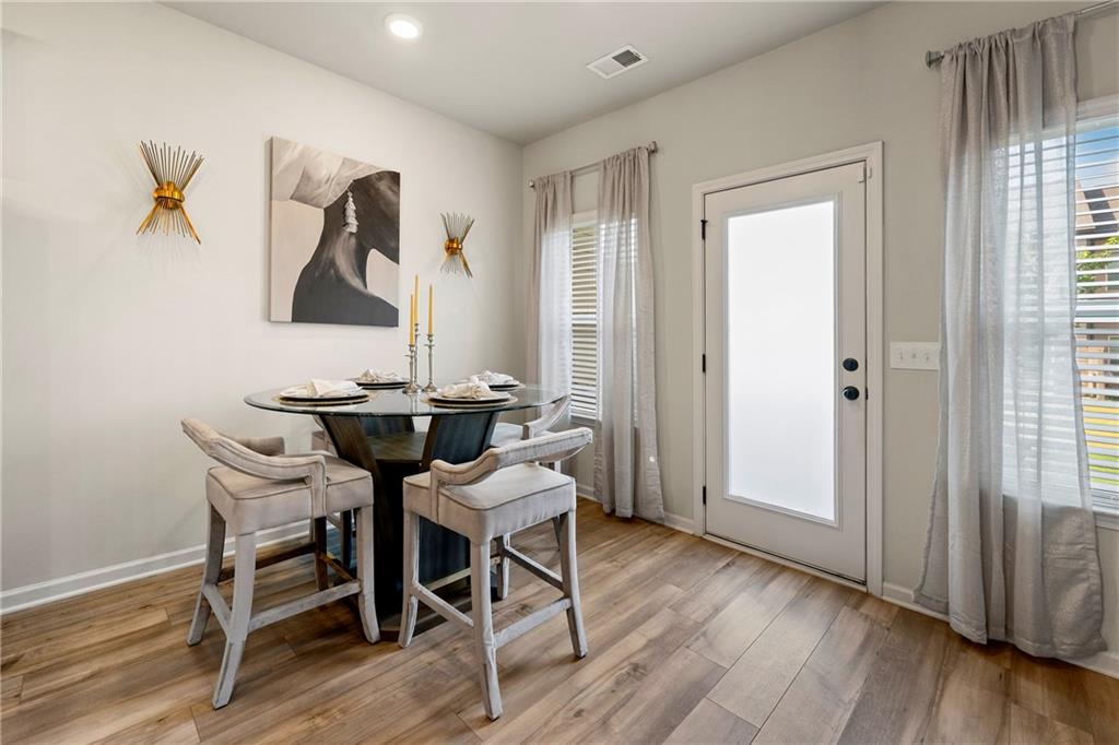 7098 Chara Lane Atlanta, GA 30331 - Photo 10 of 25 a view of a dining room with furniture and wooden floor